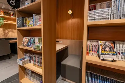 a library with wooden shelves filled with books at Gran Custama Ueno in Tokyo