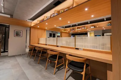 a long bar in a restaurant with stools at Gran Custama Ueno in Tokyo
