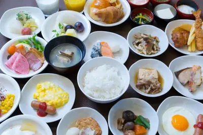 a bunch of bowls filled with different types of food at Dormy Inn Premium Tokyo Kodenmacho in Tokyo