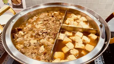 a pot of food with meat and potatoes in it at Dormy Inn Premium Tokyo Kodenmacho in Tokyo