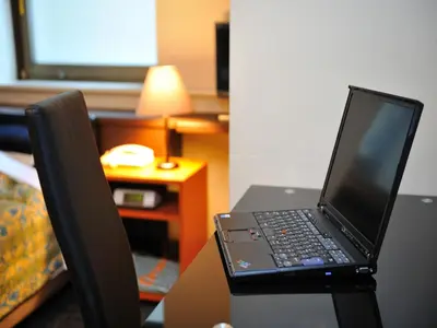 a laptop computer sitting on top of a desk at Hotel Cerezo in Tokyo