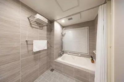 a bathroom with a tub and a shower at Hotel Cerezo in Tokyo