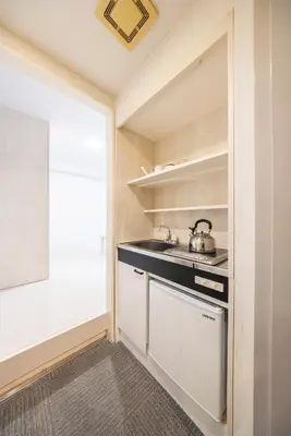 a kitchen with a sink and a stove at Hotel Cerezo in Tokyo