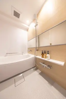a bathroom with a bath tub and a sink at Hotel Cerezo in Tokyo