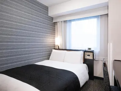 a hotel room with a bed and a window at APA Hotel Ginza Shintomicho Ekimae Kita in Tokyo