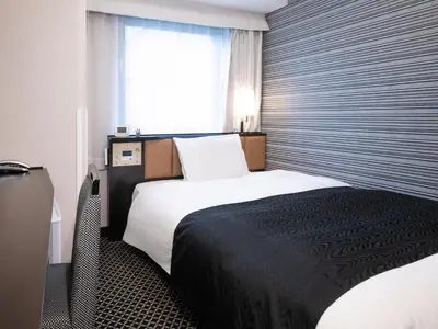 a hotel room with a bed and a window at APA Hotel Ginza Shintomicho Ekimae Kita in Tokyo