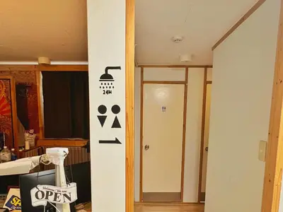 a door with a sign that says open in a room at Edo Tokyo Hostel in Tokyo