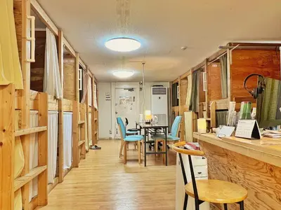 a dining room with a table and blue chairs at Edo Tokyo Hostel in Tokyo