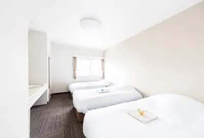 a hotel room with two beds and a sink at Best Hotel in Tokyo