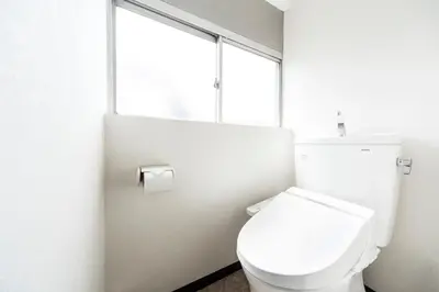 a white toilet in a bathroom with a window at Best Hotel in Tokyo