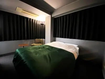 a bedroom with a bed and a table in it at Randor Residence Tokyo Classic in Tokyo