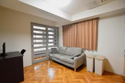 a living room with a couch and a window at Randor Residence Tokyo Classic in Tokyo
