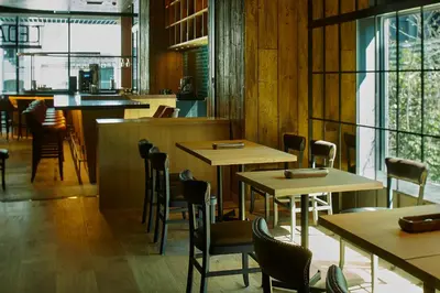 a restaurant with tables and chairs and a bar at remm Roppongi in Tokyo