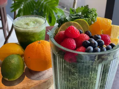 a bowl of fruit on a table with a drink at remm Roppongi in Tokyo
