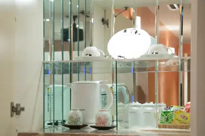 a glass shelf with cups and other items on it at HOTEL AN Shinjuku Kabukicho (Adult Only) in Tokyo