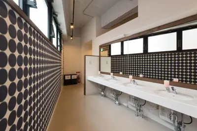 a row of sinks in a public restroom at Tokyo Guest House Itabashi-juku in Tokyo