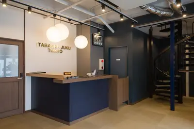 a reception desk in a room with a staircase at Tokyo Guest House Itabashi-juku in Tokyo