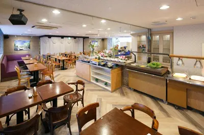 a restaurant with tables and chairs and a buffet at Day Nice Hotel Tokyo in Tokyo