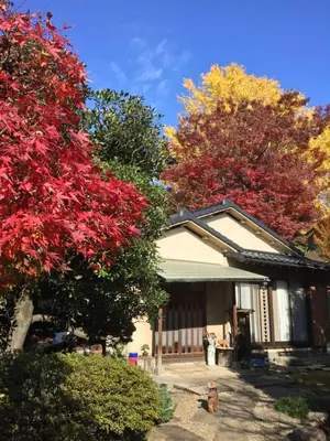 a house with colorful trees in front of it at Mokkoan in Tokyo