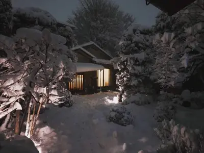a house covered in snow at night at Mokkoan in Tokyo