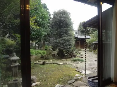 a view of a garden from a window at Mokkoan in Tokyo
