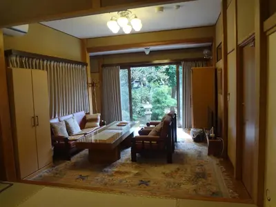 a living room with a couch and a table at Mokkoan in Tokyo