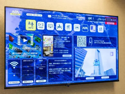 a blue board with many different stickers on it at APA Hotel TKP Nippori Ekimae in Tokyo