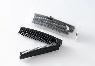 a black comb and a white package of hairbrush at APA Hotel TKP Nippori Ekimae in Tokyo