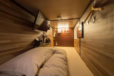 a bedroom with a bed and a tv on the wall at Anshin oyado Tokyo Woman Ginza Shiodome in Tokyo