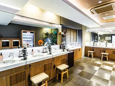 a bathroom with two sinks and a large mirror at Anshin oyado Tokyo Woman Ginza Shiodome in Tokyo