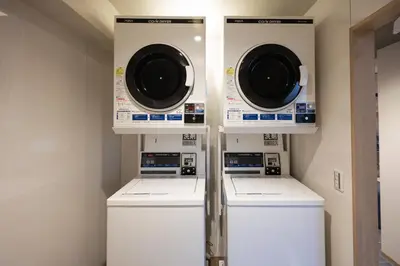 two washers and a dryer in a laundry room at Hotel Paul House in Tokyo