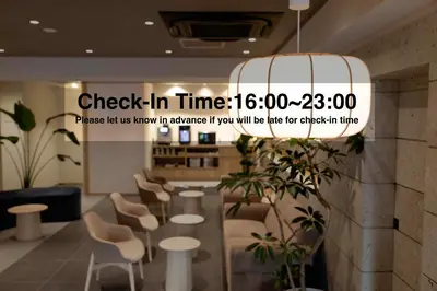 a sign that reads check in time in a lobby at Hotel Paul House in Tokyo