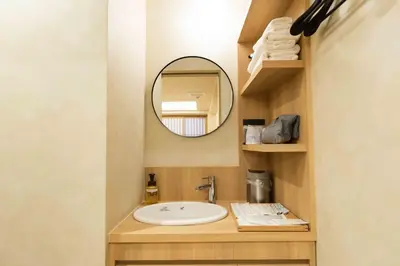 a bathroom with a sink and a mirror at Hotel Paul House in Tokyo