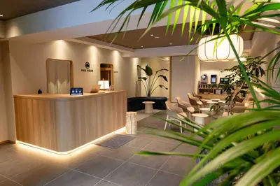 a lobby with a reception desk and chairs at Hotel Paul House in Tokyo