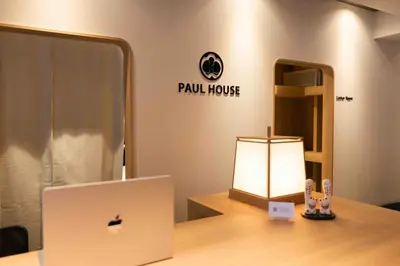 a desk with a laptop and a lamp on it at Hotel Paul House in Tokyo