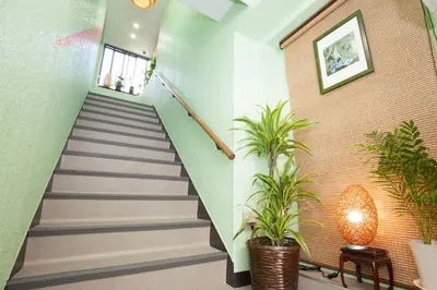 a staircase in a building with plants at Akasaka-no Sato (Female Only) in Tokyo