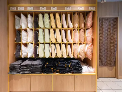 a closet filled with lots of different types of shoes at Super Hotel Ueno-Okachimachi in Tokyo