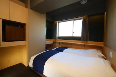 a bedroom with a large bed and a window at KOKO HOTEL Asakusa Komagata - formerly Hotel Wing International Select Asakusa Komagata in Tokyo