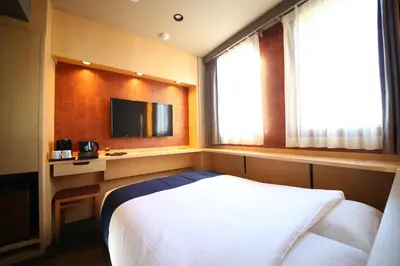 a hotel room with a bed and a television at KOKO HOTEL Asakusa Komagata - formerly Hotel Wing International Select Asakusa Komagata in Tokyo