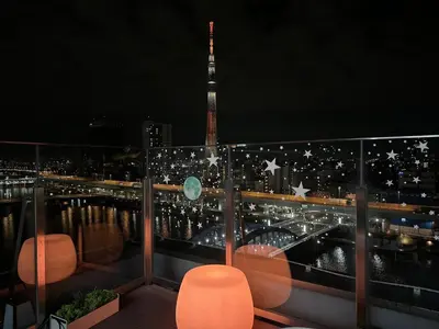 a view of the eiffel tower from a balcony at night at KOKO HOTEL Asakusa Komagata - formerly Hotel Wing International Select Asakusa Komagata in Tokyo