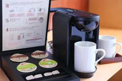 a coffee maker and cups on a table at KOKO HOTEL Asakusa Komagata - formerly Hotel Wing International Select Asakusa Komagata in Tokyo