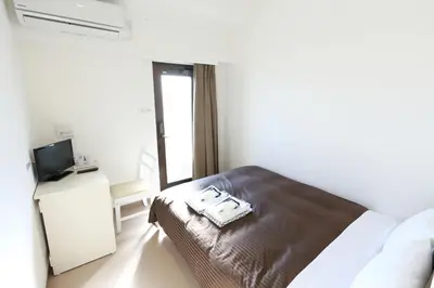 a hotel room with a bed and a television at Oak Hotel Edo in Tokyo