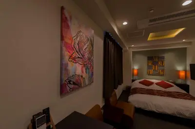 a hotel room with a bed and a table in a room at Hotel COREST (Adult Only) in Tokyo
