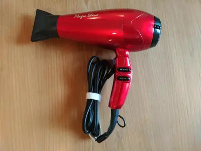 a red blow dryer sitting on top of a table at Hotel Axas Nihonbashi in Tokyo