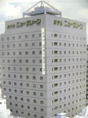 a large white building with a sign on it at Hotel New Green Okachimachi in Tokyo