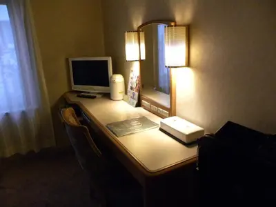 a desk with a computer and a monitor on it at Hotel New Green Okachimachi in Tokyo