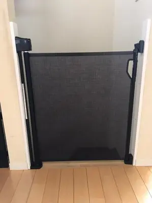 a black garage door in a room with a wooden floor at Luxury New House in Tokyo