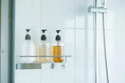 four bottles ofodorizers on a shelf in a bathroom at LYURO Tokyo Kiyosumi by THE SHARE HOTELS in Tokyo