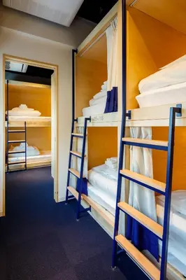 a room with bunk beds and a hallway at LYURO Tokyo Kiyosumi by THE SHARE HOTELS in Tokyo