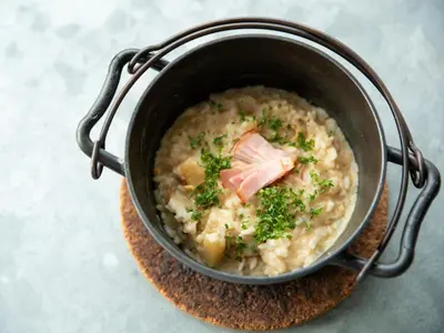 a pot of food with meat and broccoli in it at LYURO Tokyo Kiyosumi by THE SHARE HOTELS in Tokyo